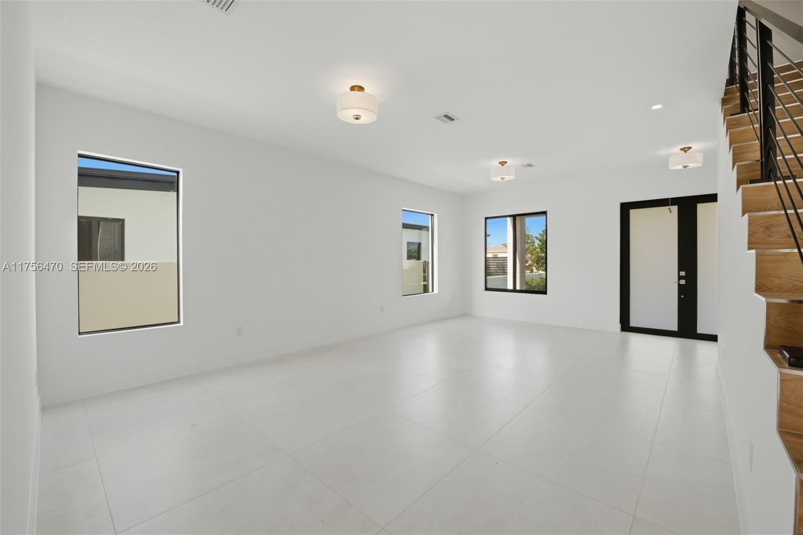 2725 Southwest 65th Avenue Miami, FL 33155 - Photo 6 of 36 a view of an empty room with a window and wooden floor