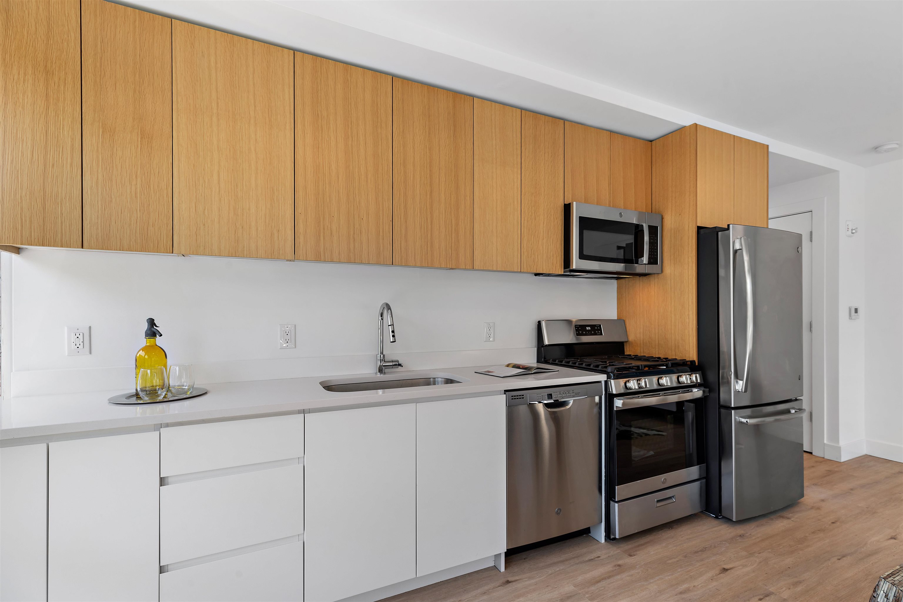 a kitchen with stainless steel appliances granite countertop a stove a sink and a refrigerator