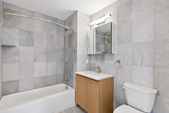 a bathroom with a sink toilet and bathtub