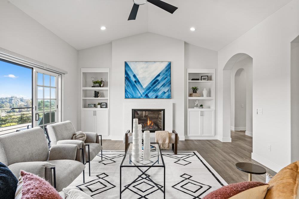 40 Indy Circle Soquel, CA 95073 - Photo 11 of 65 a living room with furniture a fireplace and a floor to ceiling window
