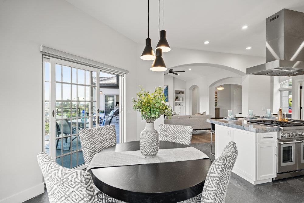 40 Indy Circle Soquel, CA 95073 - Photo 21 of 65 a dining room with wooden floor a chandelier a wooden table and chairs
