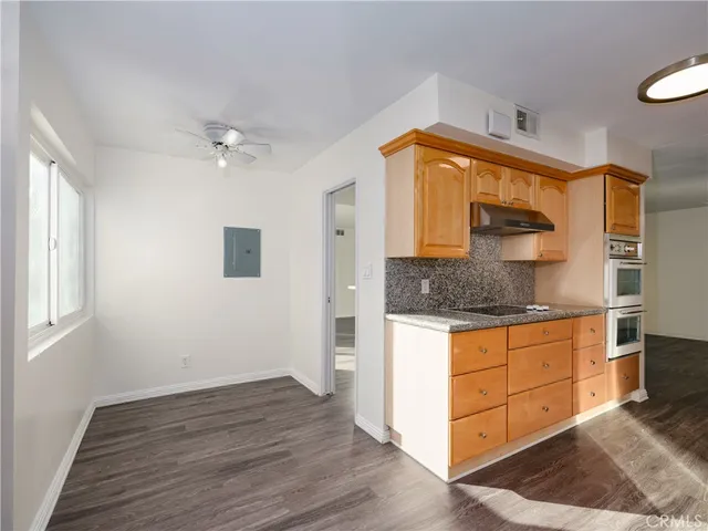 a kitchen with granite countertop a sink and a stove top oven