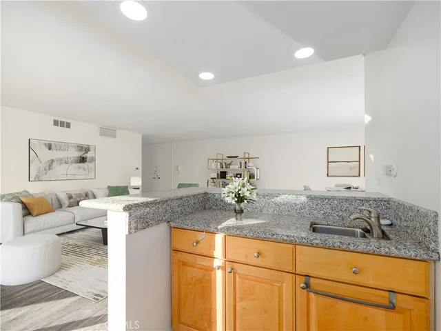 a living room with granite countertop furniture and painting on the wall