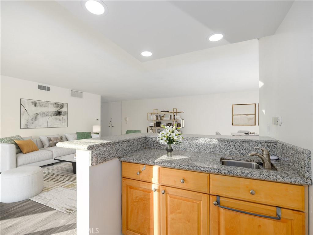 5411 Tyrone Avenue Sherman Oaks, CA 91401 - Photo 14 of 28 a living room with granite countertop furniture and painting on the wall
