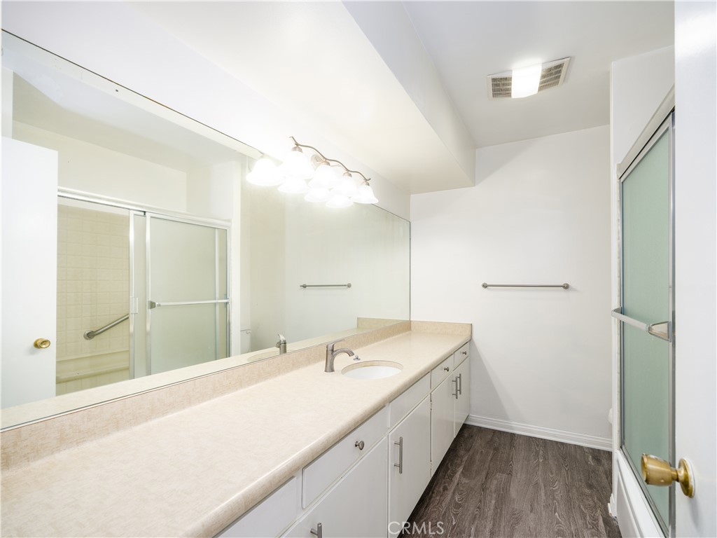 5411 Tyrone Avenue Sherman Oaks, CA 91401 - Photo 19 of 28 a bathroom with a sink a mirror and a shower