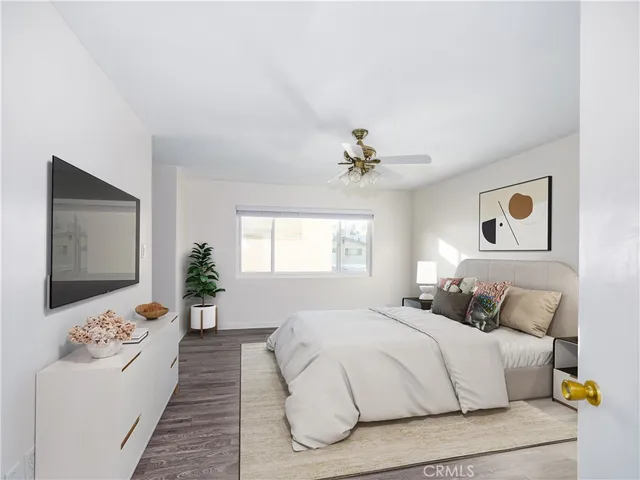 a bedroom with a large bed and a chandelier
