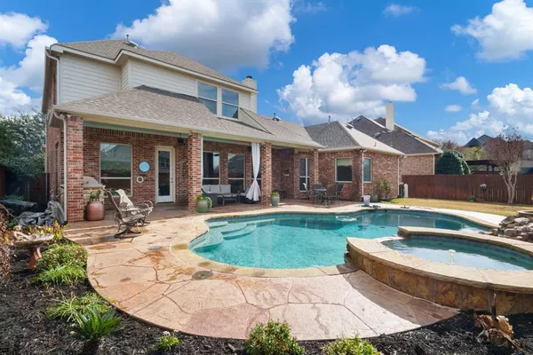 a view of a house with swimming pool and sitting area