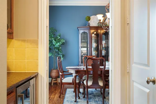 a view of a dining room with furniture and chandelier
