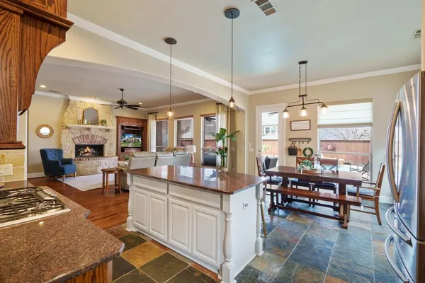 a view of a dining room and livingroom with furniture wooden floor a chandelier