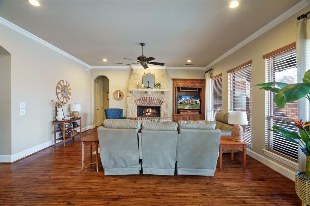 9144 Calvert Road Lantana, TX 76226 - Photo 18 of 40 a living room with fireplace furniture and a wooden floor