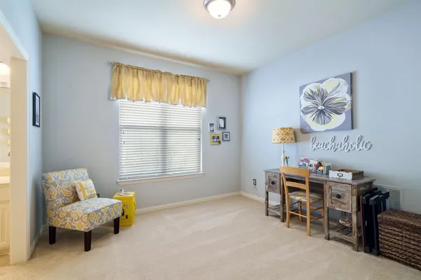 a bedroom with furniture and a window