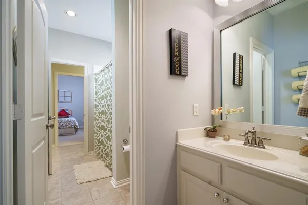 a en suite bathroom with a sink and mirror