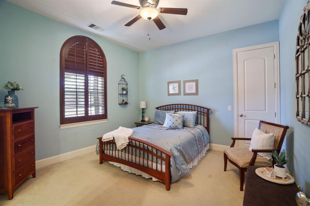 9144 Calvert Road Lantana, TX 76226 - Photo 25 of 40 a bedroom with a bed and a chandelier