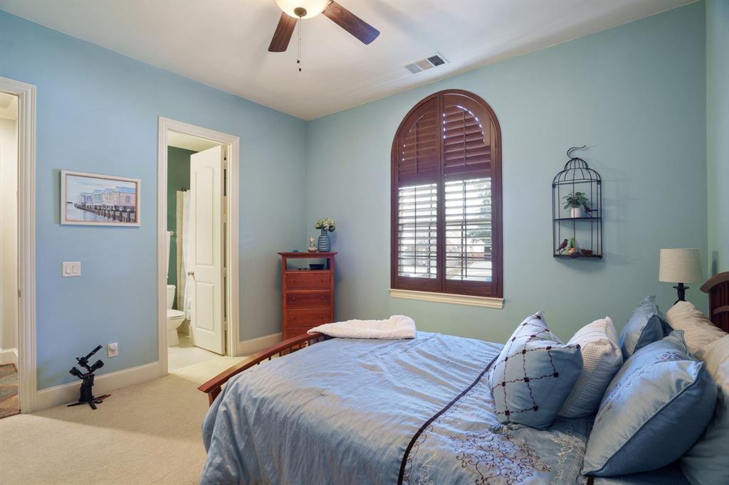 9144 Calvert Road Lantana, TX 76226 - Photo 26 of 40 a bedroom with a bed and a chandelier