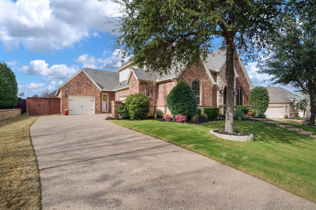 9144 Calvert Road Lantana, TX 76226 - Photo 3 of 40 a front view of a house with a yard
