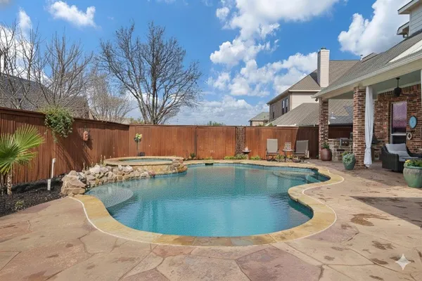 a view of a swimming pool with a patio