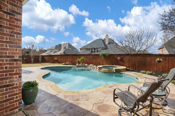 a view of a swimming pool with lounge chairs