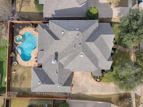 an aerial view of residential houses with outdoor space