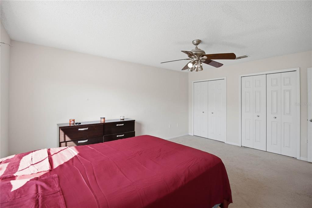 206 Taranto Way Kissimmee, FL 34758 - Photo 30 of 45 a bedroom with a bed and a chandelier