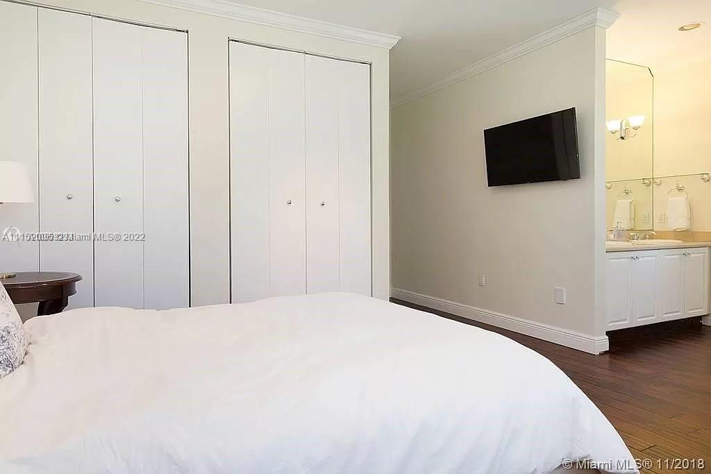 272 Fernwood Road Key Biscayne, FL 33149 - Photo 11 of 30 a bedroom with a bed and a flat screen tv