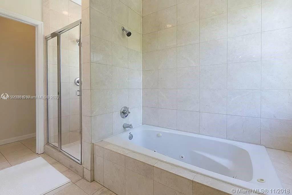 272 Fernwood Road Key Biscayne, FL 33149 - Photo 12 of 30 a bathroom with a bathtub and shower