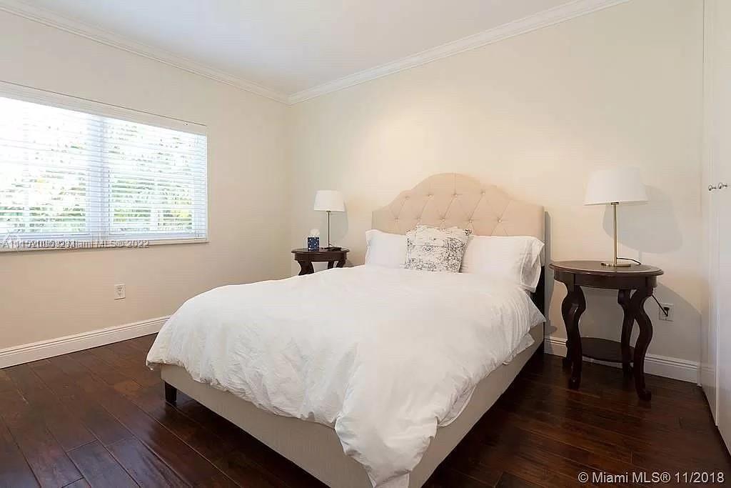 272 Fernwood Road Key Biscayne, FL 33149 - Photo 13 of 30 a large bed sitting in a bedroom next to a window