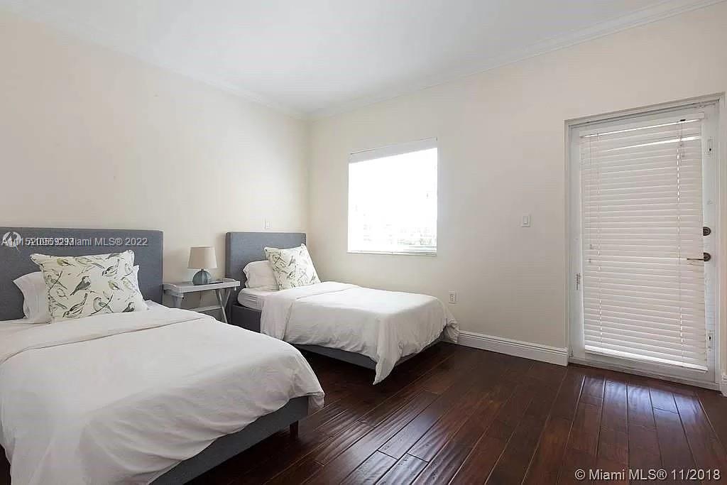 272 Fernwood Road Key Biscayne, FL 33149 - Photo 16 of 30 a bedroom with two beds and wooden floor