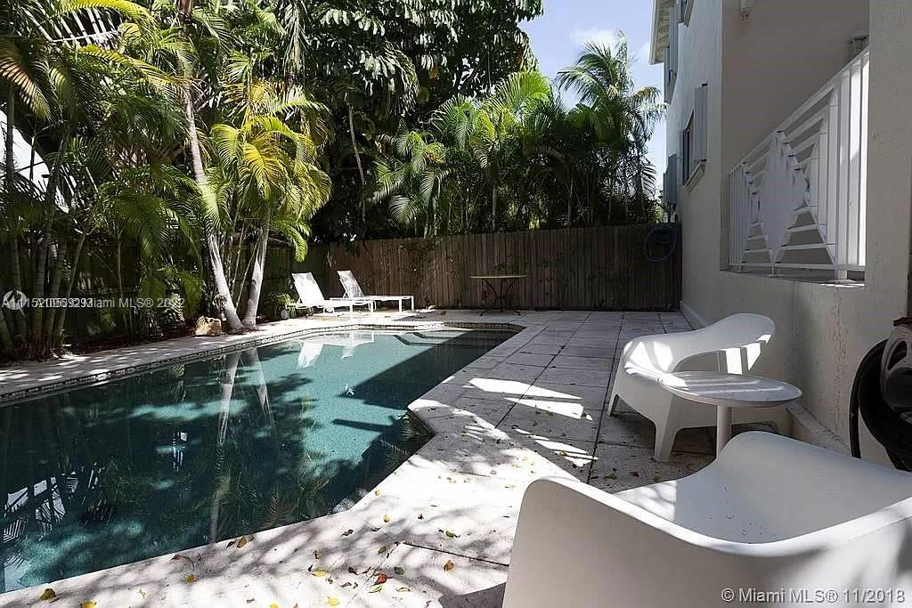272 Fernwood Road Key Biscayne, FL 33149 - Photo 17 of 30 a backyard of a house with table and chairs