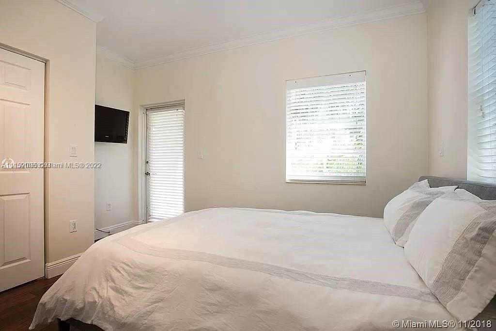 272 Fernwood Road Key Biscayne, FL 33149 - Photo 19 of 30 a bedroom with a bed and a window