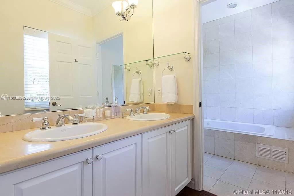 272 Fernwood Road Key Biscayne, FL 33149 - Photo 20 of 30 a bathroom with a sink and a mirror