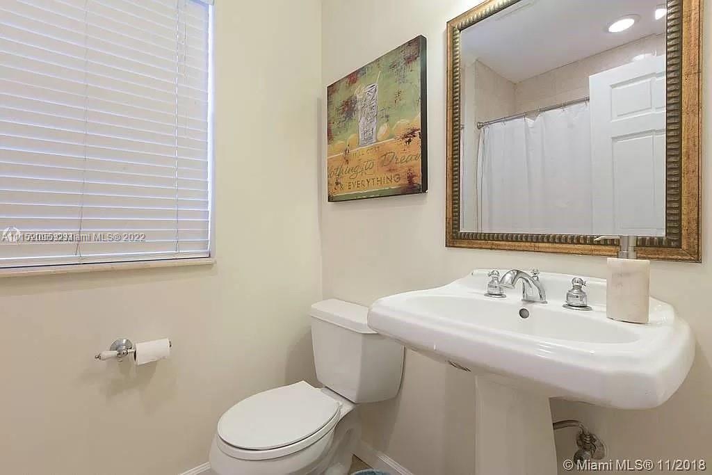 272 Fernwood Road Key Biscayne, FL 33149 - Photo 23 of 30 a bathroom with a sink mirror and toilet