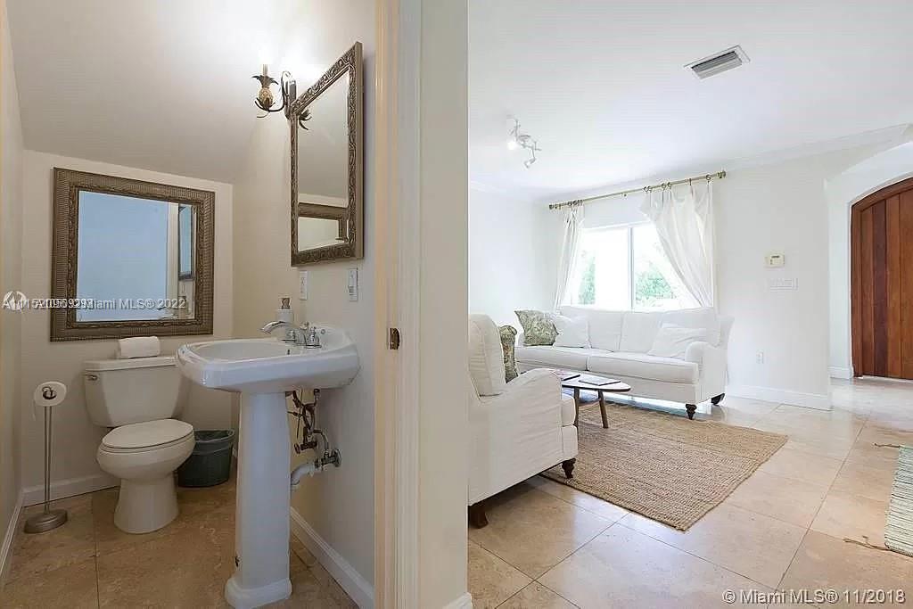 272 Fernwood Road Key Biscayne, FL 33149 - Photo 4 of 30 a bathroom with a sink toilet and mirror