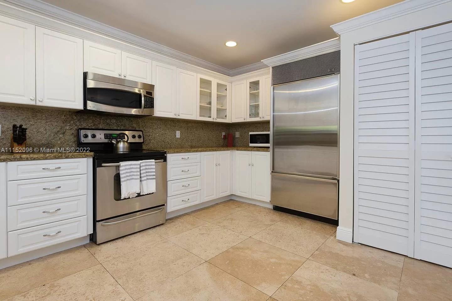 272 Fernwood Road Key Biscayne, FL 33149 - Photo 7 of 30 a kitchen with stainless steel appliances granite countertop a stove a sink and a refrigerator
