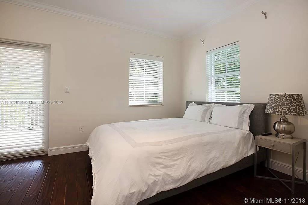 272 Fernwood Road Key Biscayne, FL 33149 - Photo 8 of 30 a bedroom with a bed and wooden floor