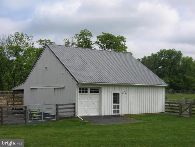 525 Howard Farm Road Shepherdstown, WV 25443 - Photo 1 of 19 a front view of a house with a garden and yard