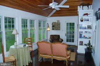 525 Howard Farm Road Shepherdstown, WV 25443 - Photo 3 of 19 a dining room with furniture a floor to ceiling window and potted plants