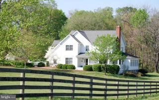 525 Howard Farm Road Shepherdstown, WV 25443 - Photo 6 of 19 a view of a white house in middle of green field