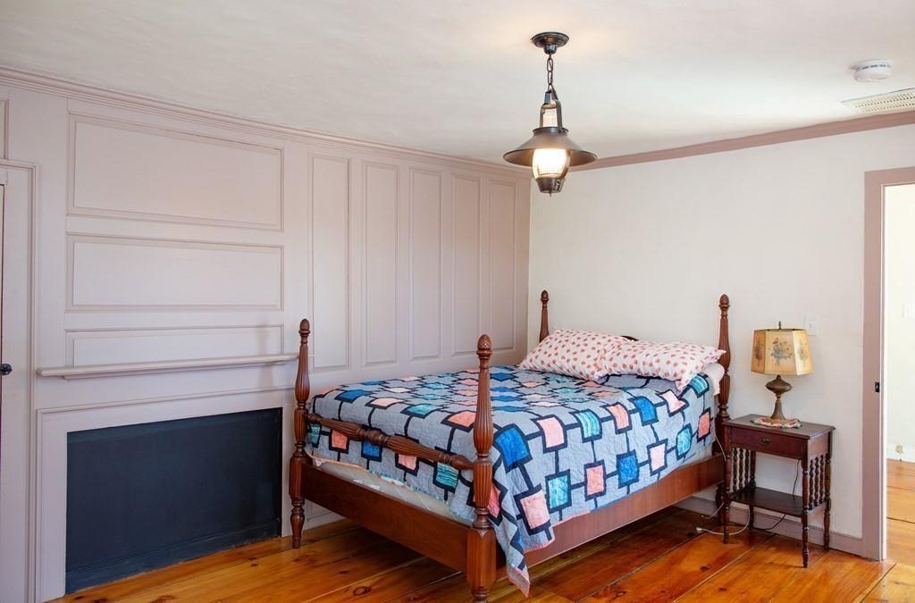 117 River Road Merrimac, MA 01860 - Photo 38 of 42 a bedroom with a bed and a chandelier