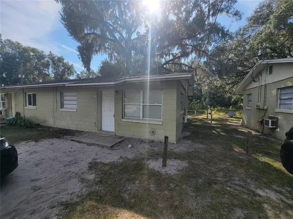 a view of a house with a yard and garage