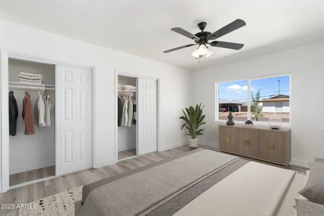 a bedroom with a bed a ceiling fan and a rug
