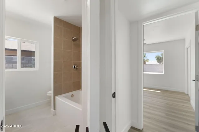 a bedroom with a bed and ceiling fan