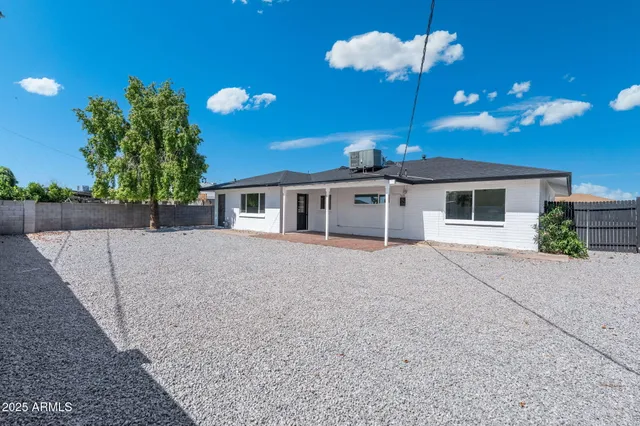 a view of a house with a yard and a garage
