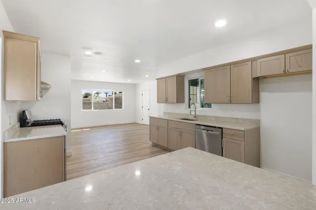 a large bathroom with a large mirror vanity sink and stainless steel appliances