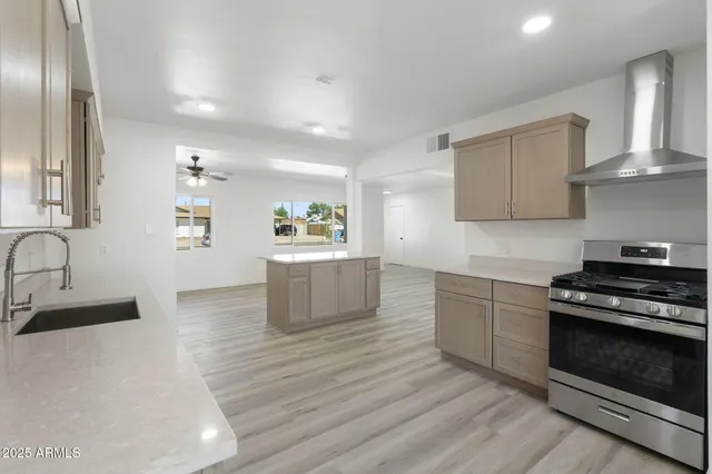 a large kitchen with a stove a sink and a refrigerator