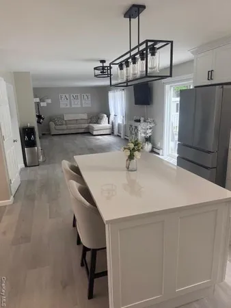 a kitchen with stainless steel appliances a sink and a refrigerator