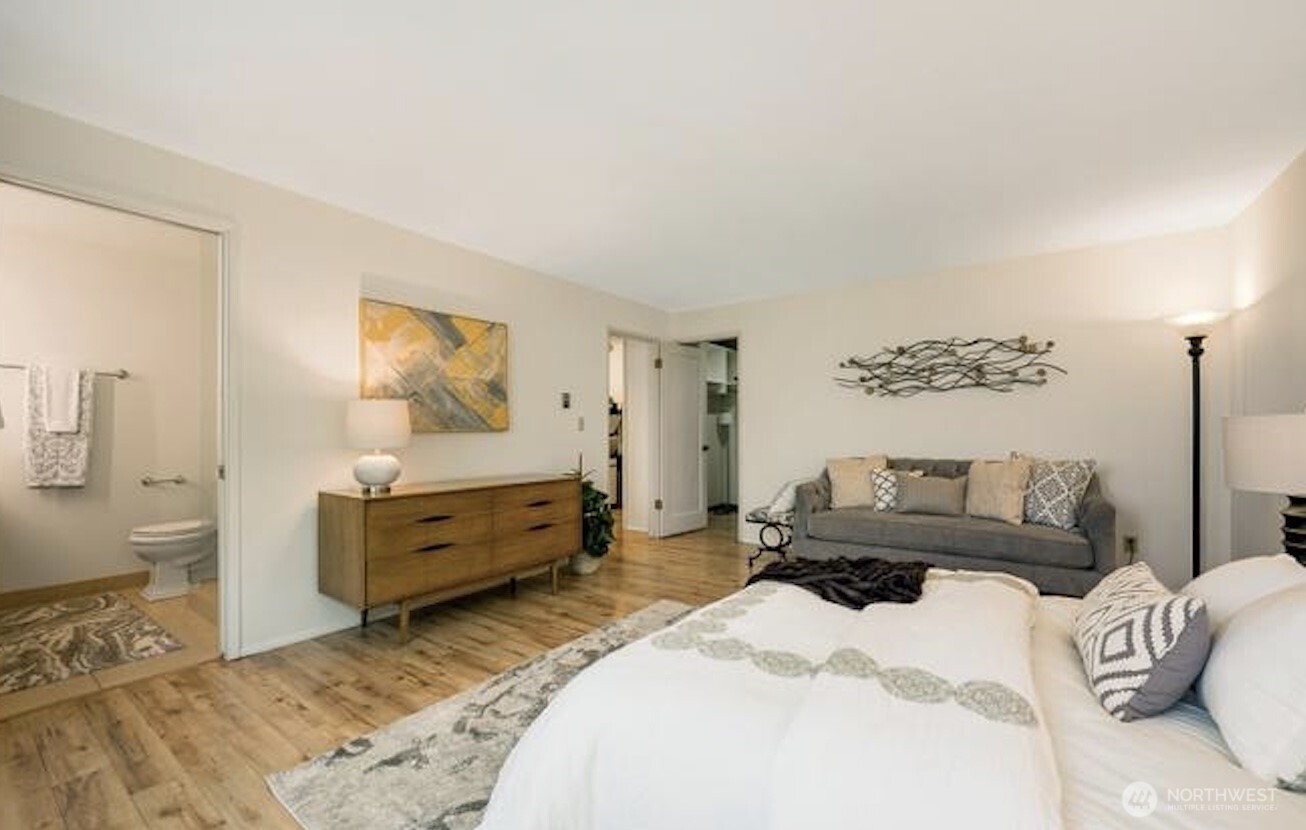 617 West Mercer Place, Unit 401 Seattle, WA 98119 - Photo 12 of 15 a bedroom with a bed and wooden floor