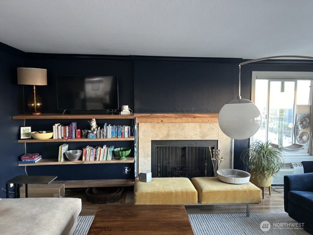 617 West Mercer Place, Unit 401 Seattle, WA 98119 - Photo 6 of 15 a living room with furniture and a flat screen tv