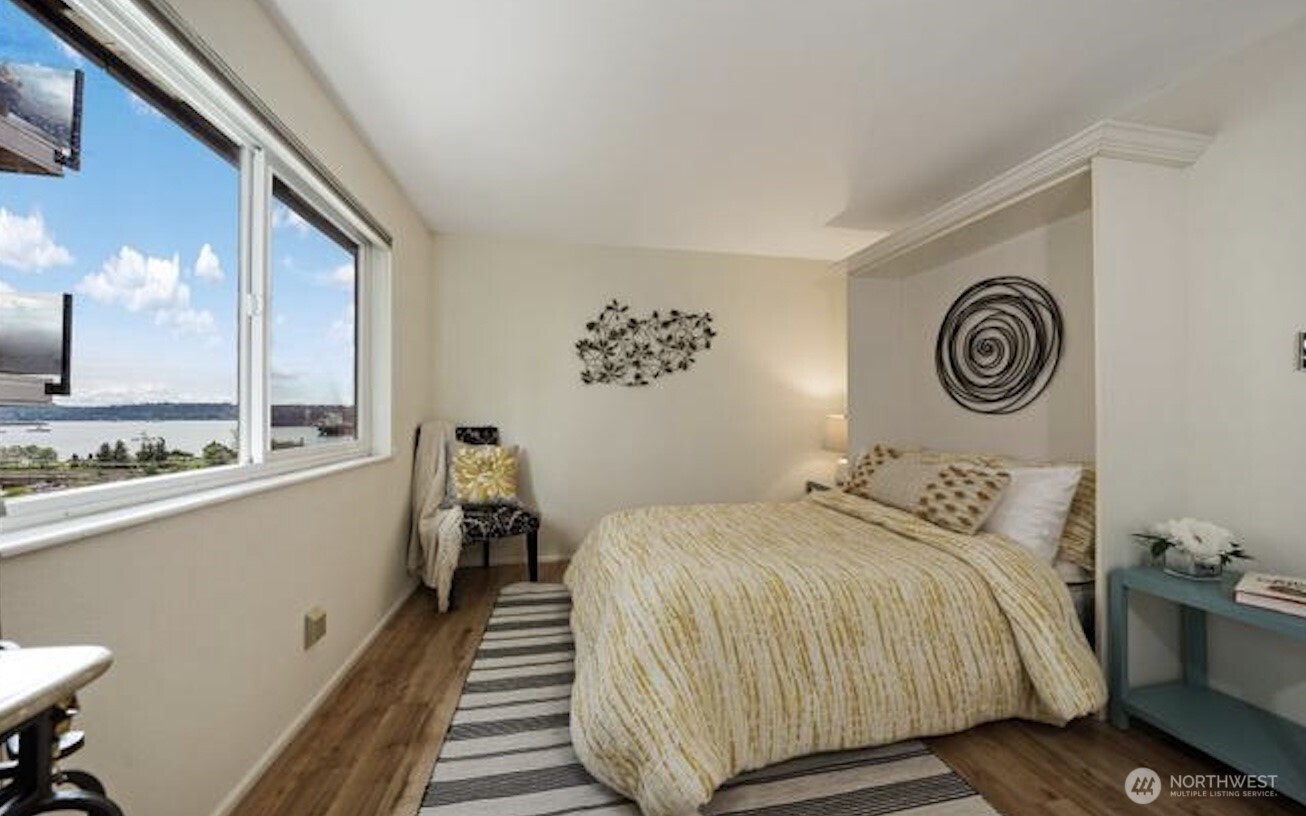 617 West Mercer Place, Unit 401 Seattle, WA 98119 - Photo 9 of 15 a bedroom with a bed and a large mirror on the dresser