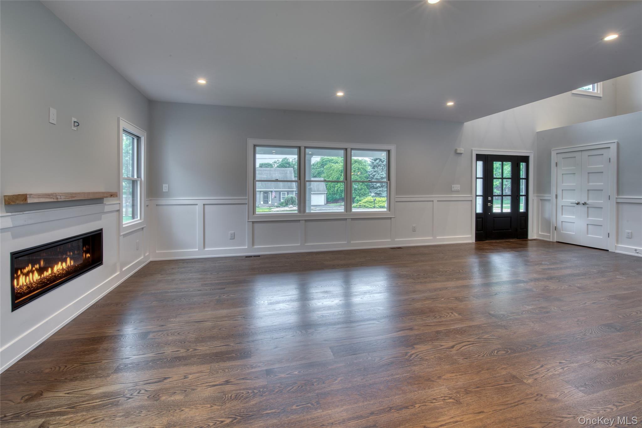 435 Maple Lane Greenport, NY 11944 - Photo 11 of 44 an empty room with windows and a fireplace