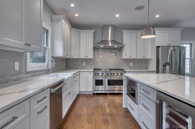 a kitchen with stainless steel appliances granite countertop a stove a sink and a refrigerator